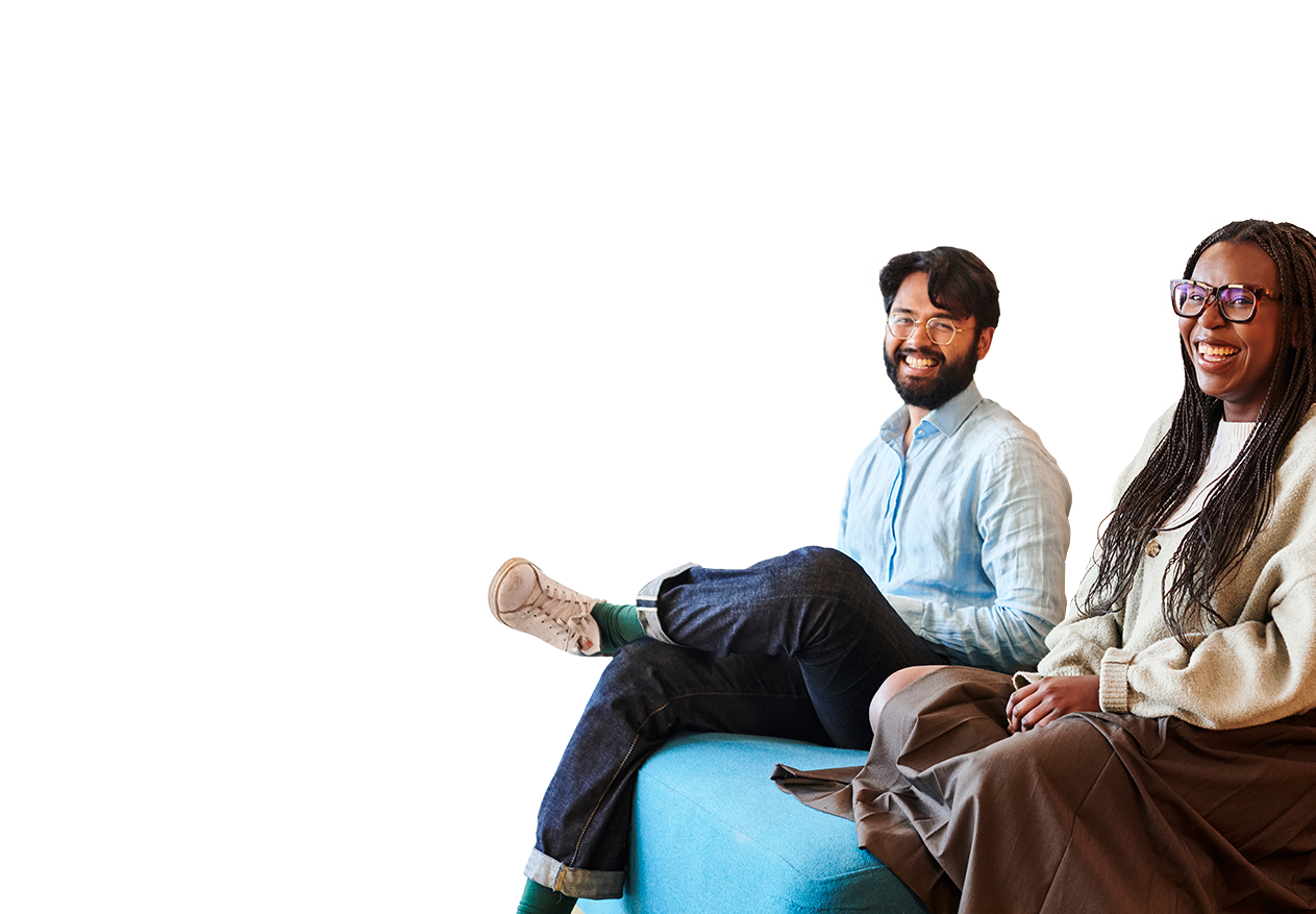Two Deliveroo employees sitting down smiling
