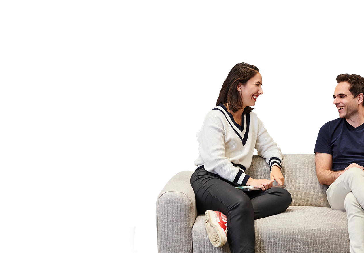 Two Deliveroo employees sitting on a sofa