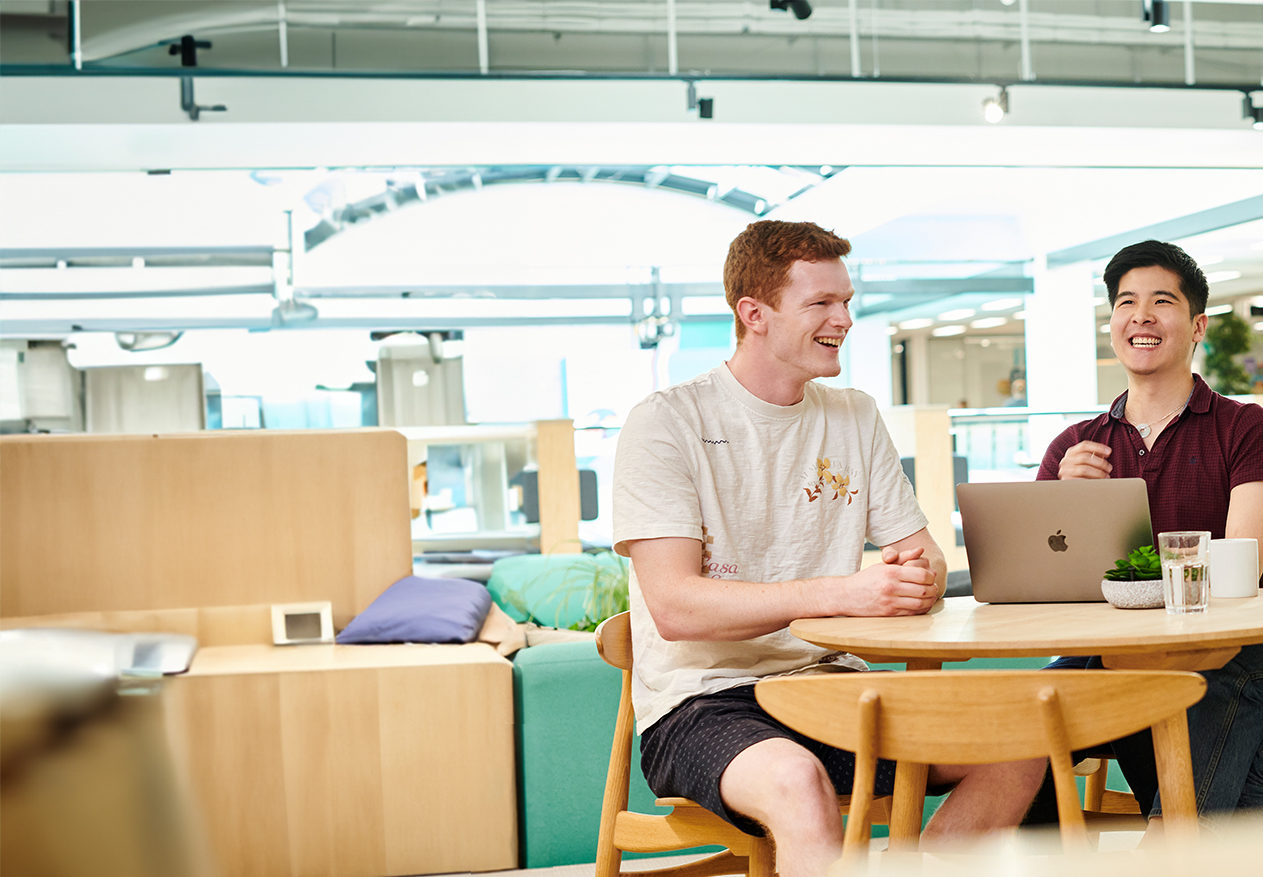 Two Deliveroo employees working together in the office