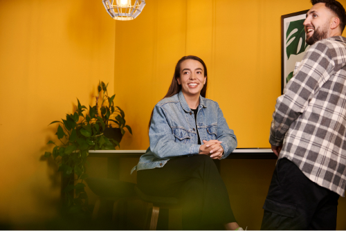 A Deliveroo employee looking up and smiling
