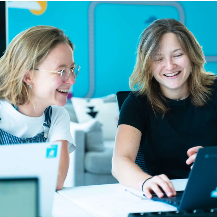 Deliveroo employees laughing together at work