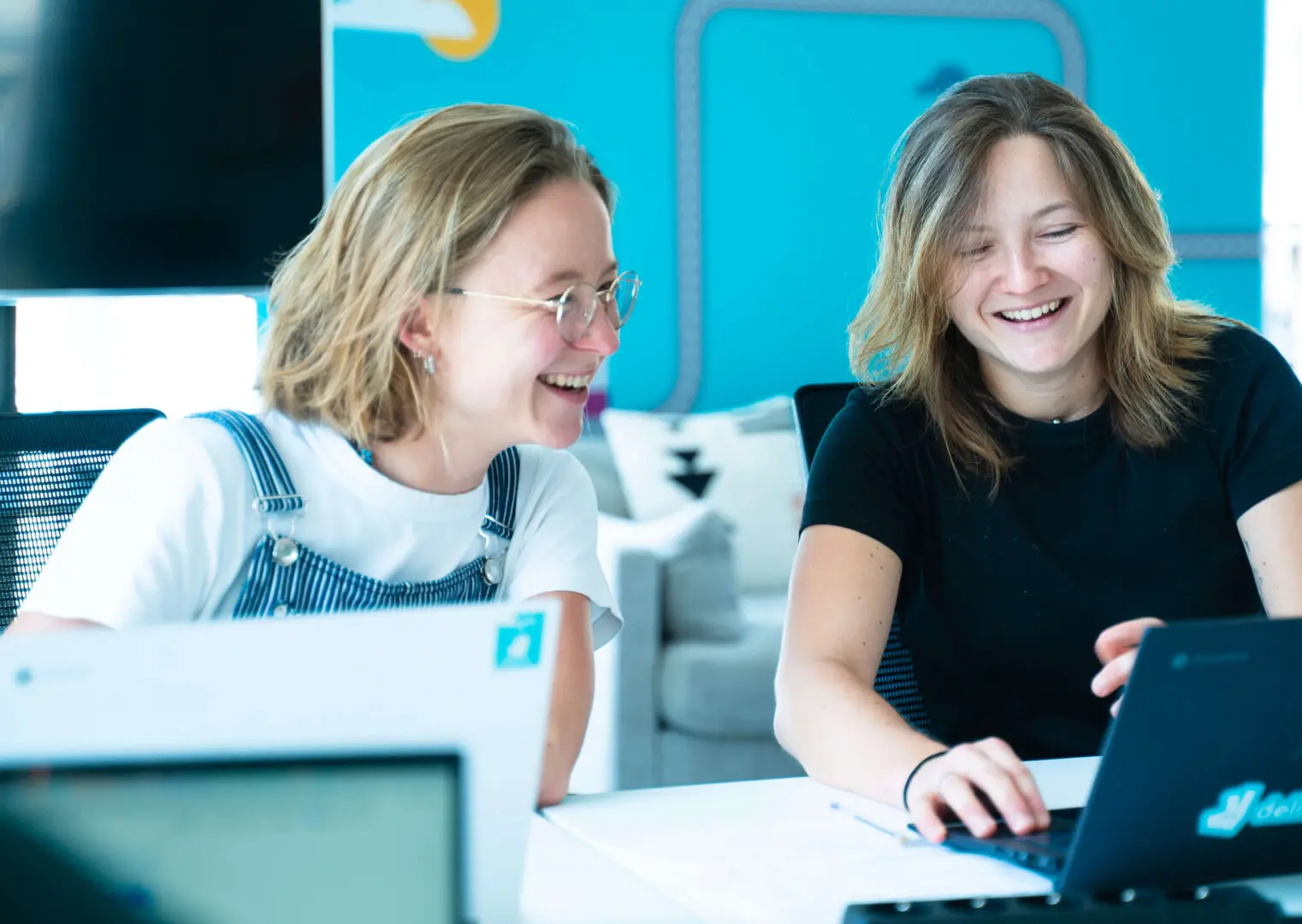 Two women working and laughing together