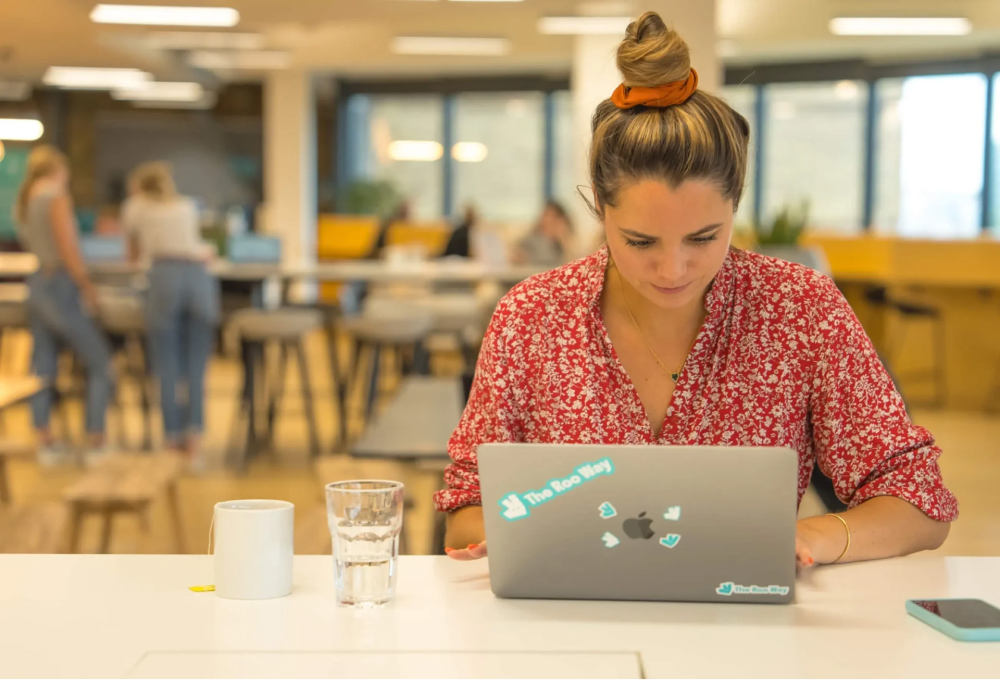 Deliveroo employee working at laptop