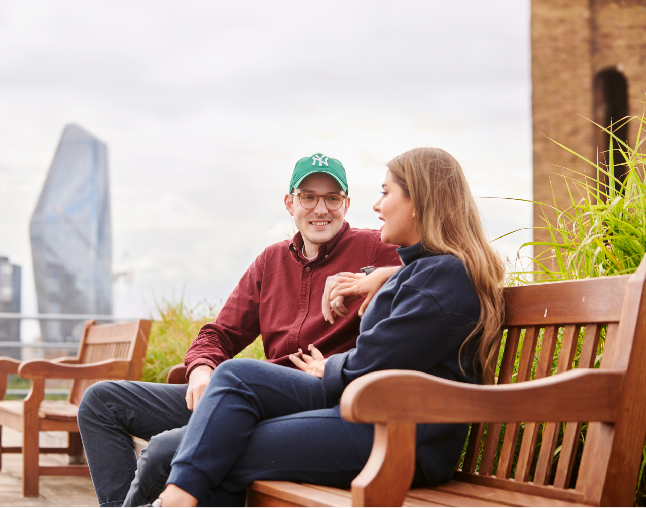 Two Deliveroo employees on bench